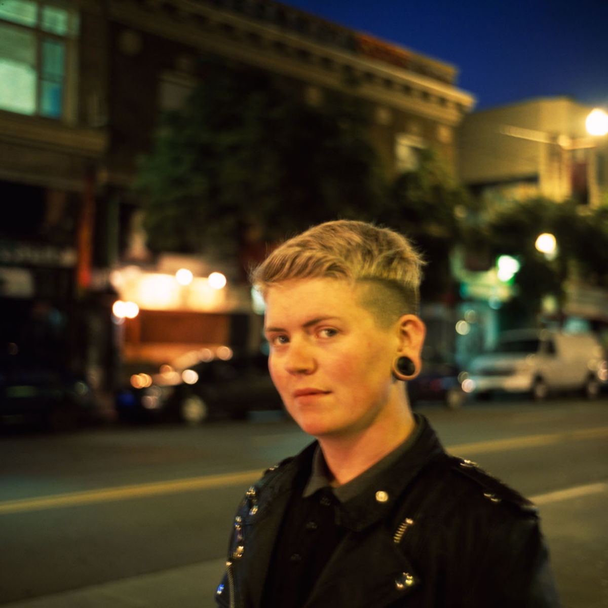 Portrait of a person facing away from a busy street. Frances Before Twilight, San Francisco, 2014.